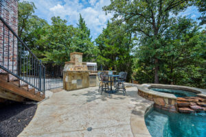 PebbleTex pool with spa, water features and pizza oven. 